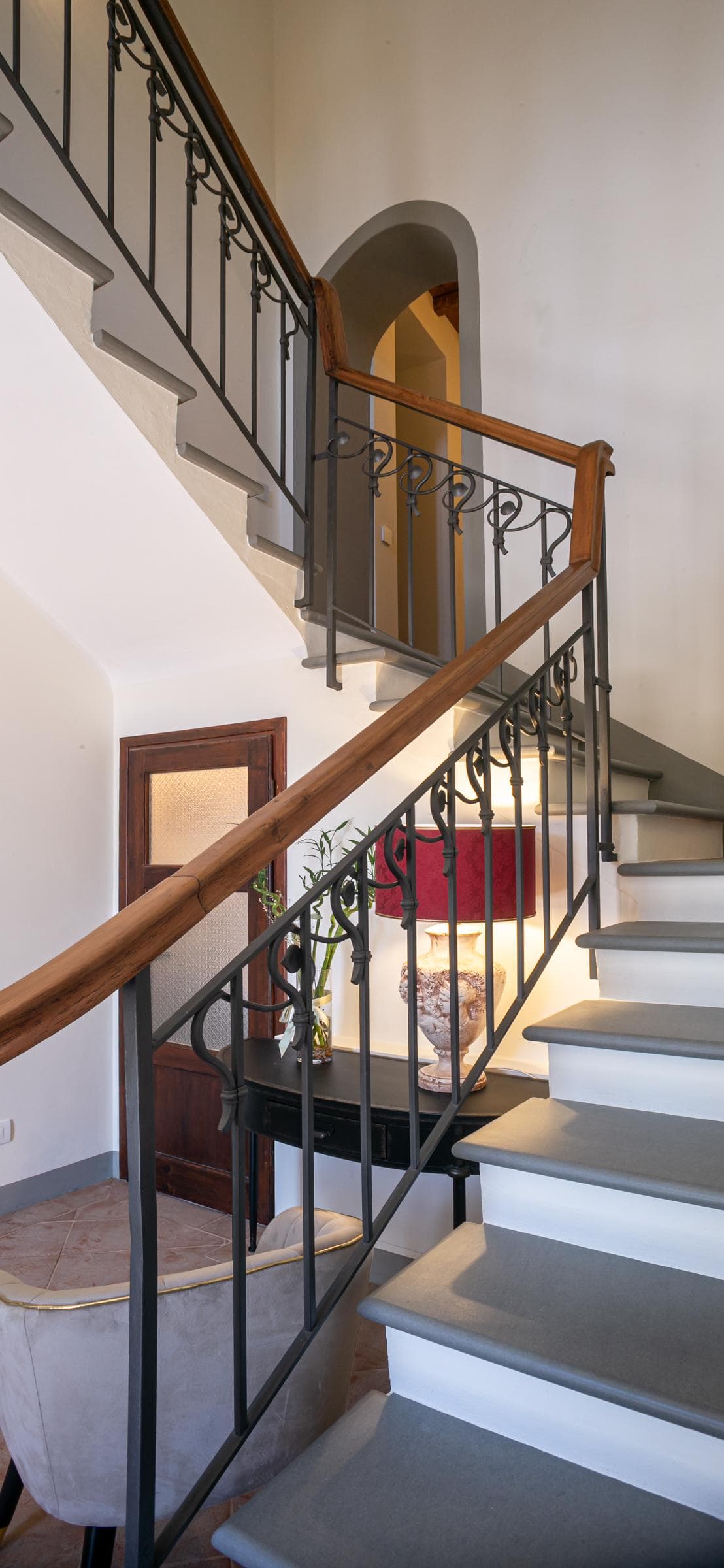 Sweeping staircase and wrought-iron balustrade